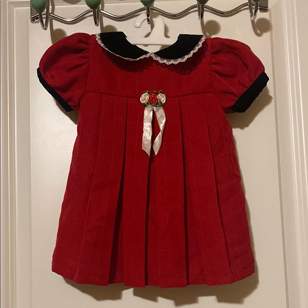 Expressions red baby’s dress with black velvet collar